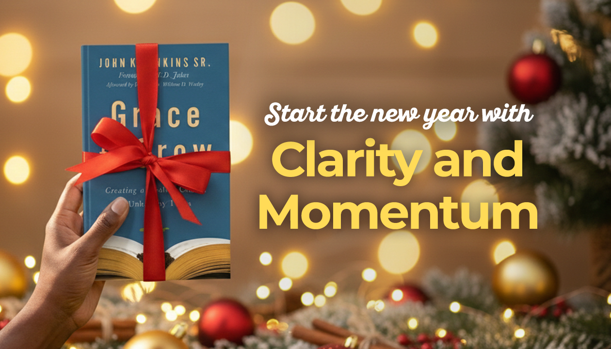 A person’s hand holds up a copy of the book